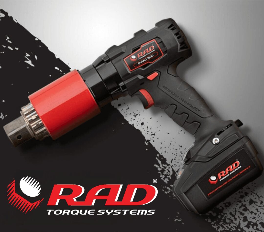 A close-up of a RAD Torque Systems cordless power tool on a gray surface.